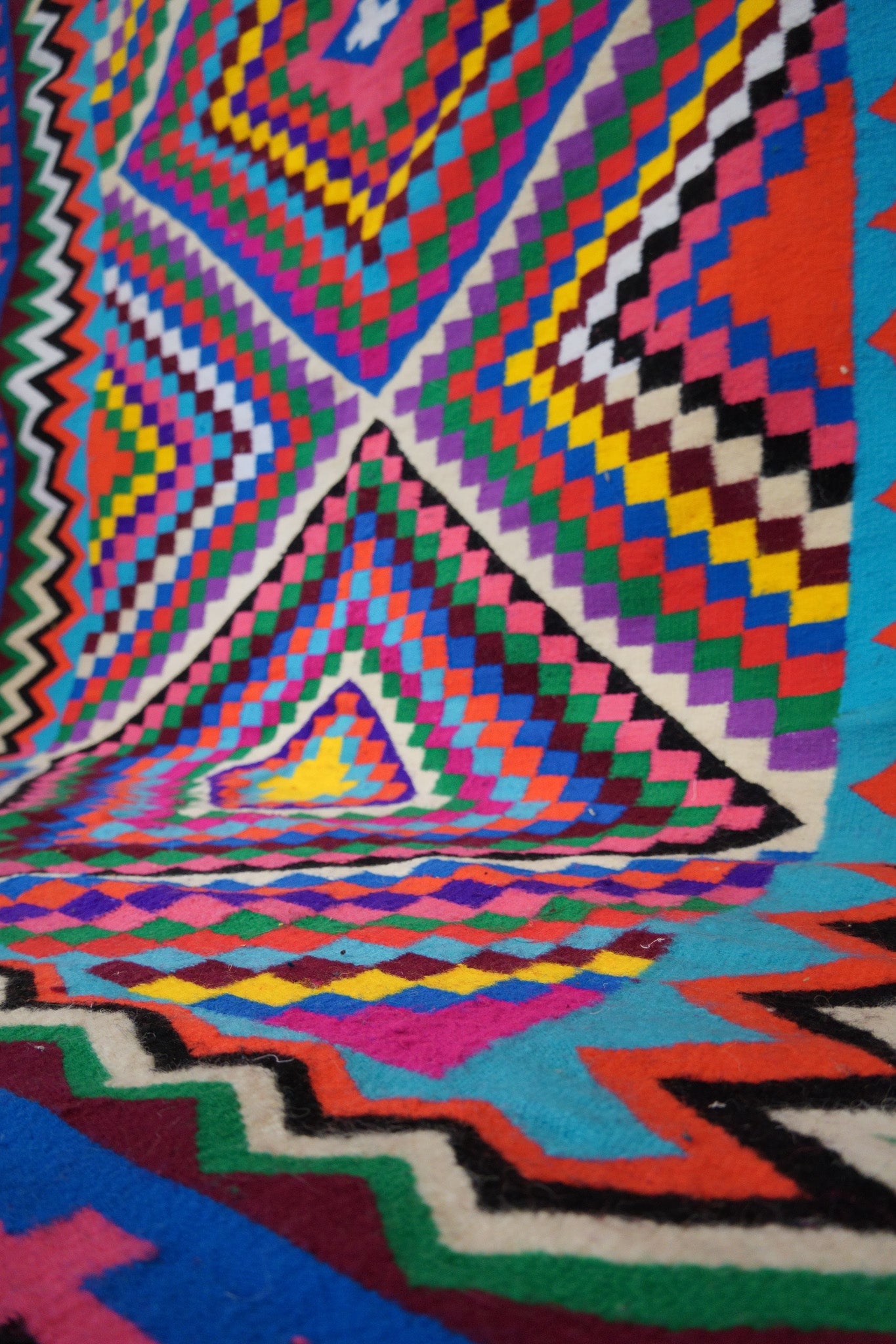 Angled close-up showing zigzag and diamond pattern in bright colors.