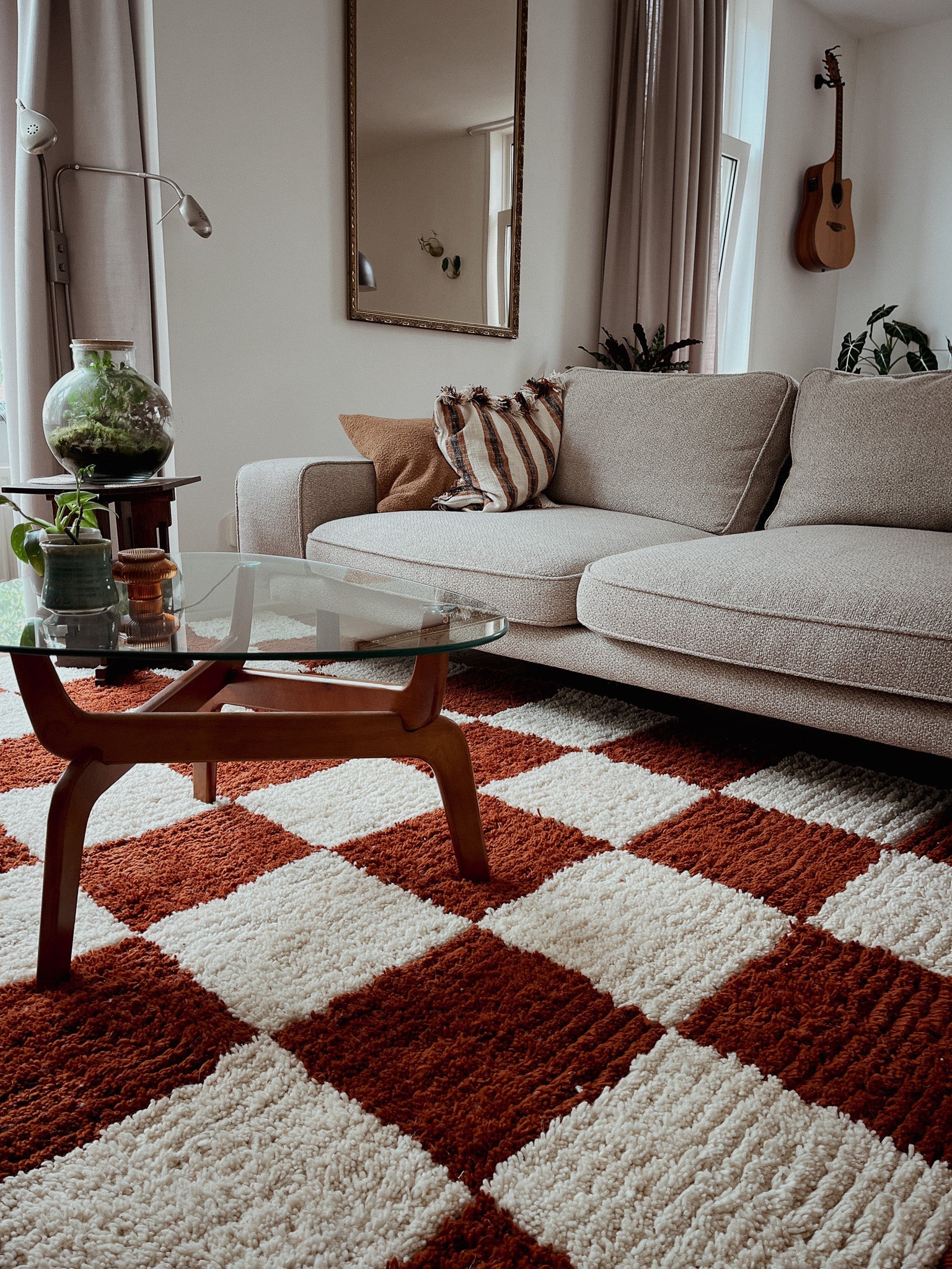 Fatma handmade Berber rug styled in a living room with a rug, beige sofa, and glass coffee table.