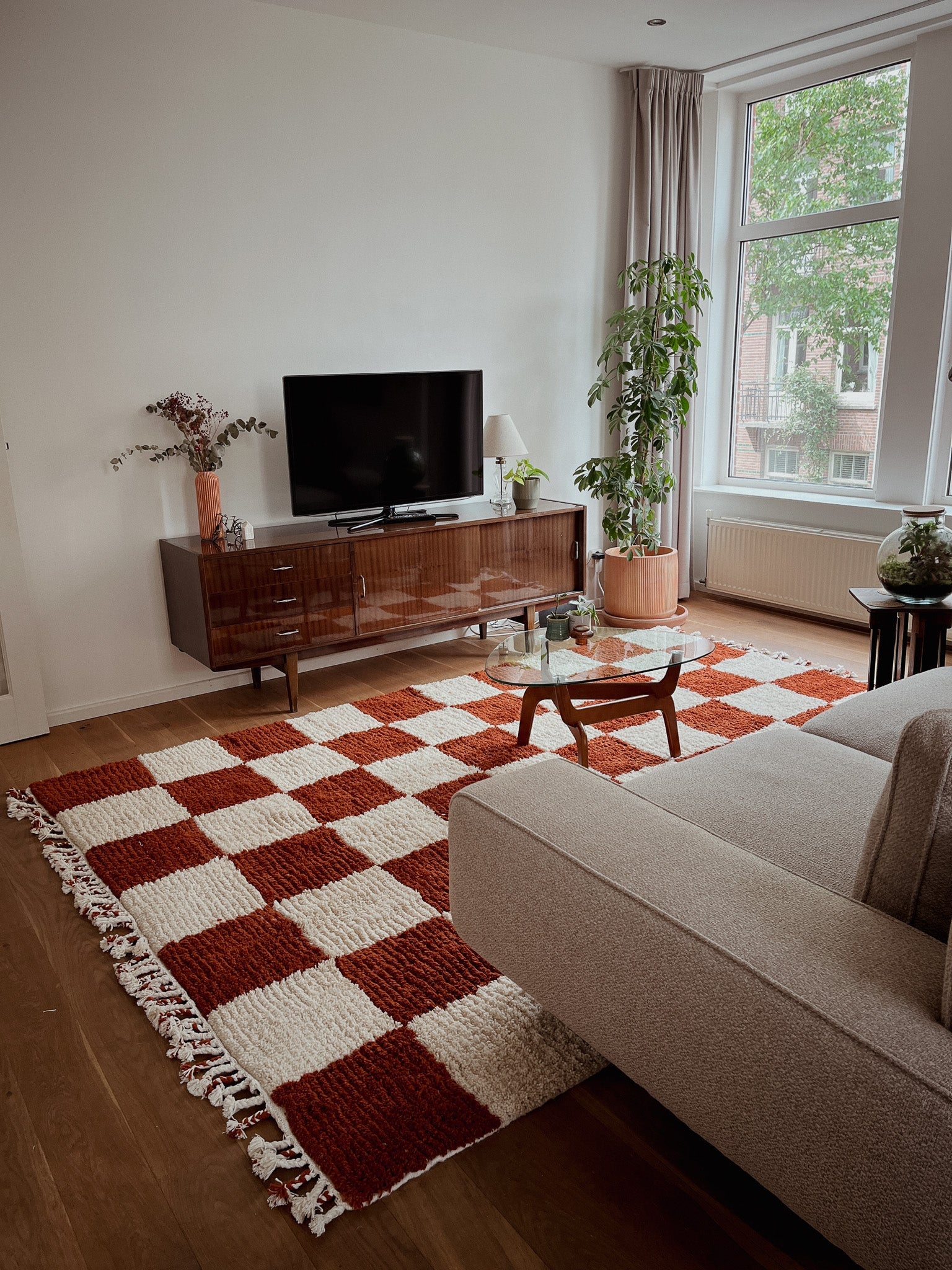 Wide view of the Fatma rug in a modern living space, surrounded by furniture and soft natural light