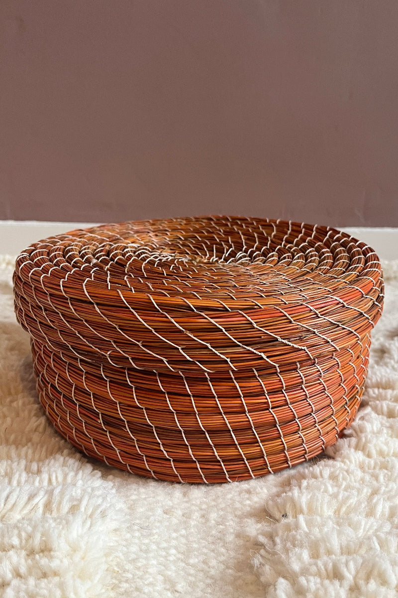 Handmade straw basket Karima in bold orange, full view.
