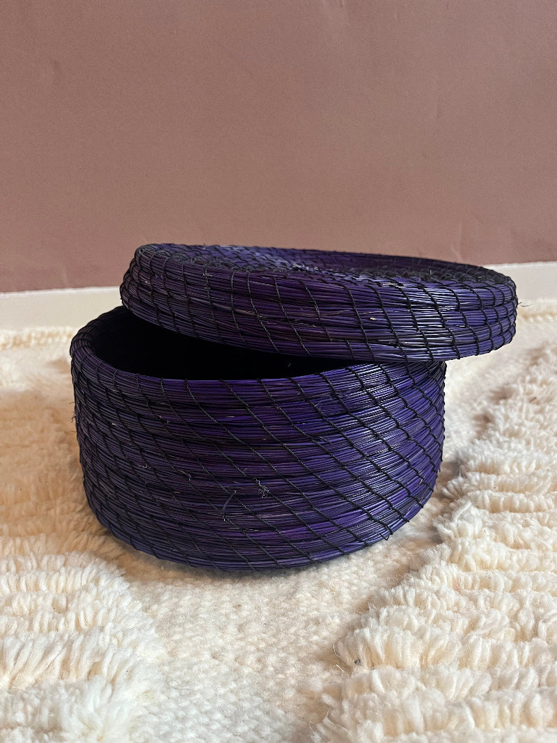 Karima purple straw basket with lid slightly open.