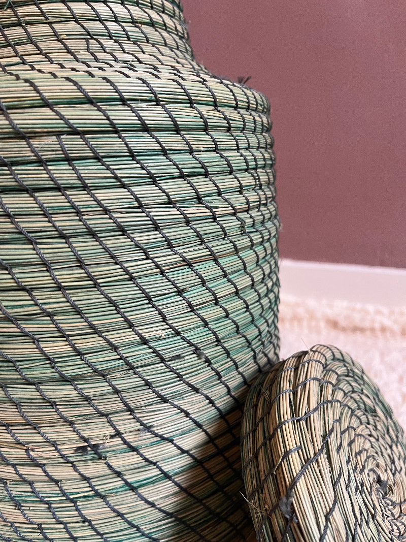 Close-up detail of straw weave pattern in green handmade basket.