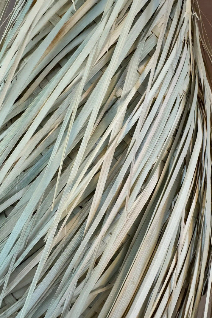 Close-up of woven palm fibre texture on the Noor handmade lampshade.