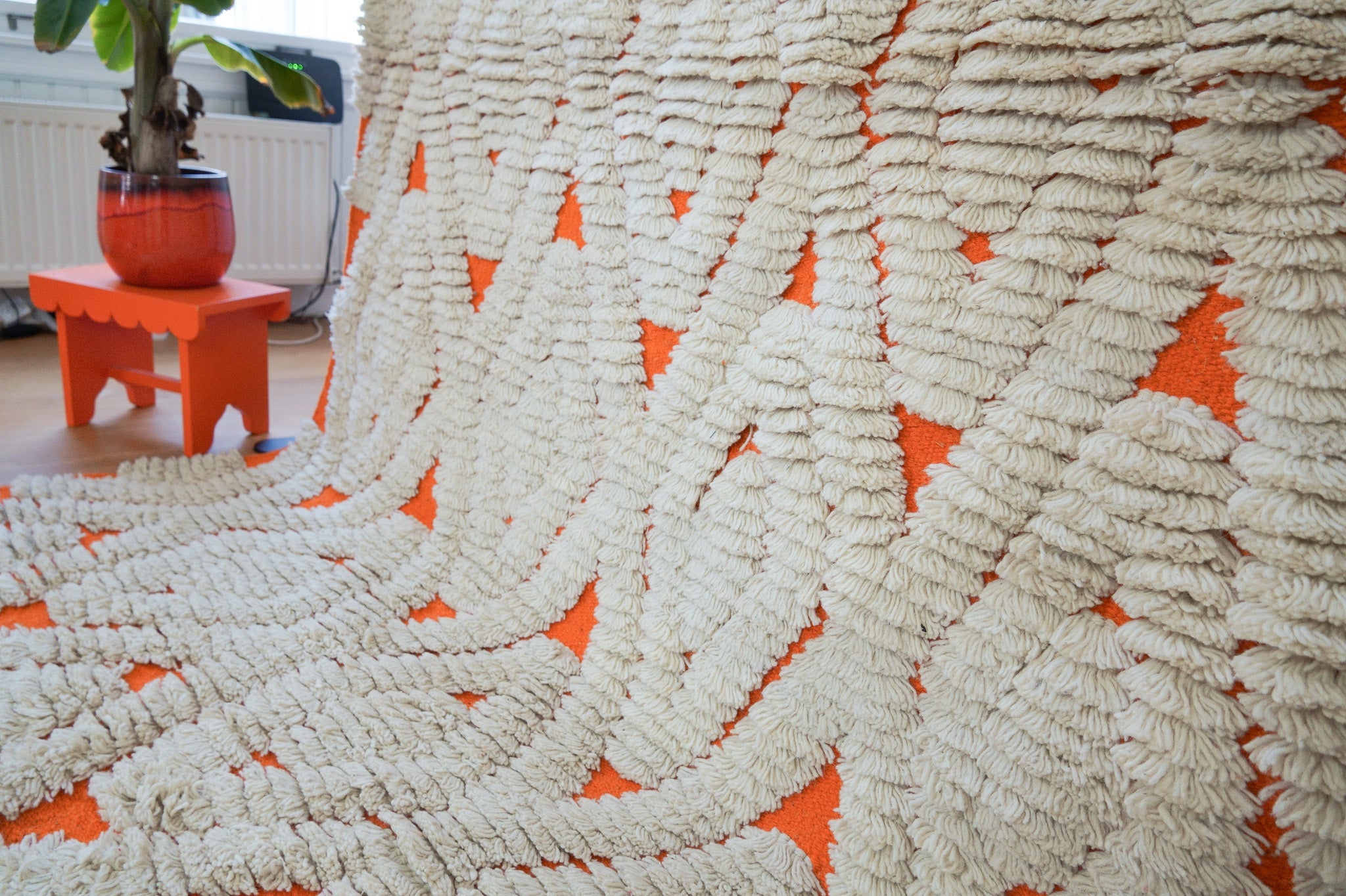 Close-up of orange & cream diamond weave and wool pile