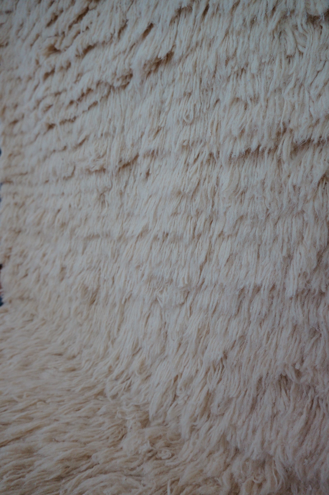 Angled view of the Samira handmade Berber rug laid on floor, showing thickness and weave