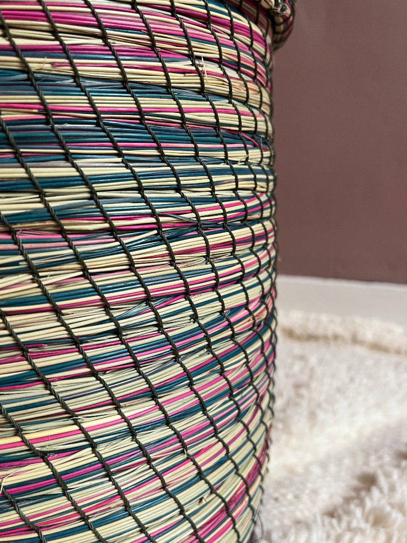 Close-up of natural straw weave with pink, green & cream tones.
