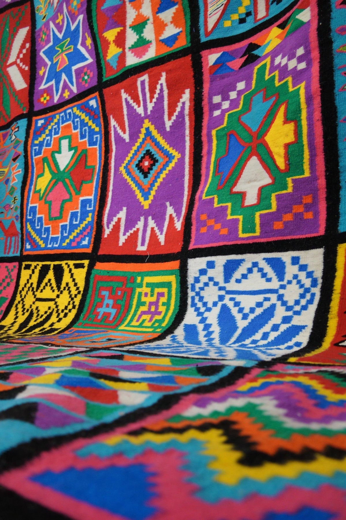 Angled close-up of patchwork motifs in vibrant colors.