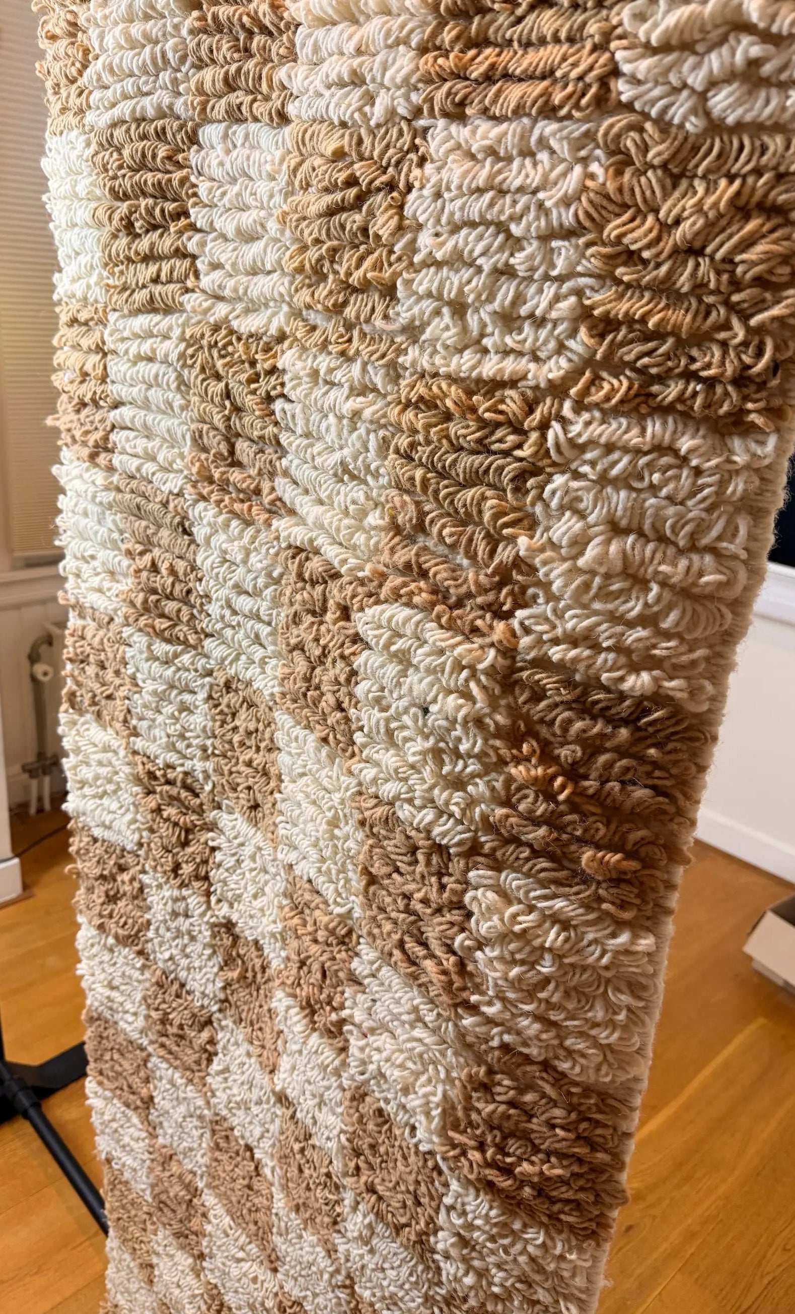 Sabrine handmade Berber wool runner, side view showing the full camel beige and cream checkerboard pattern and looped pile depth, handmade in Tunisia.
