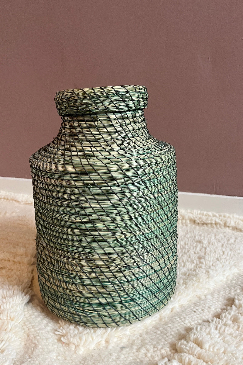 Handmade straw basket Nabila in green with lid, full view.