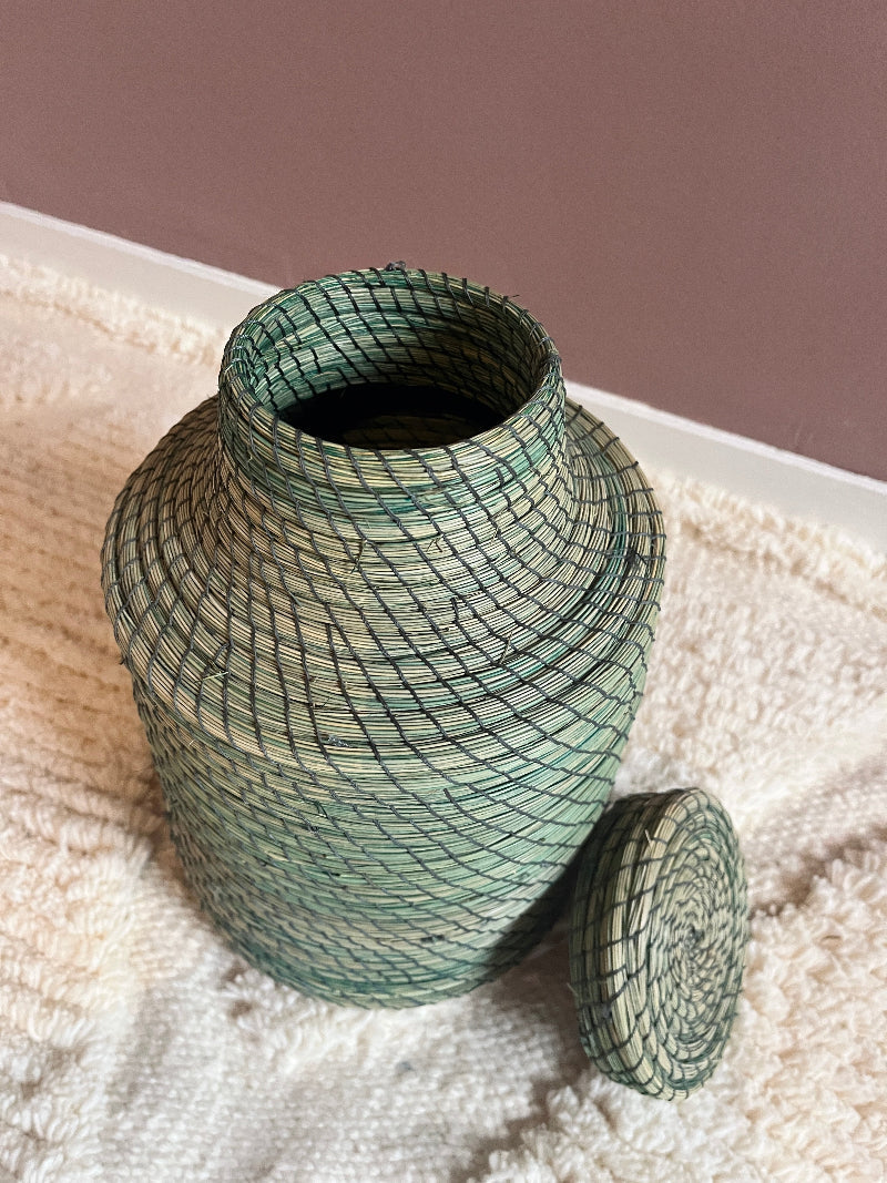 Handmade green straw basket Nabila with lid removed.
