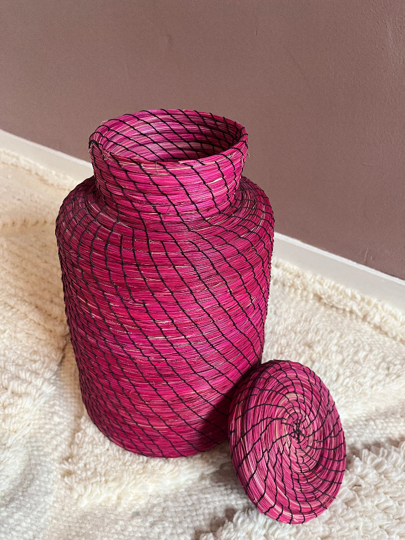 Top angled detail of woven pink straw basket Nabila with lid removed