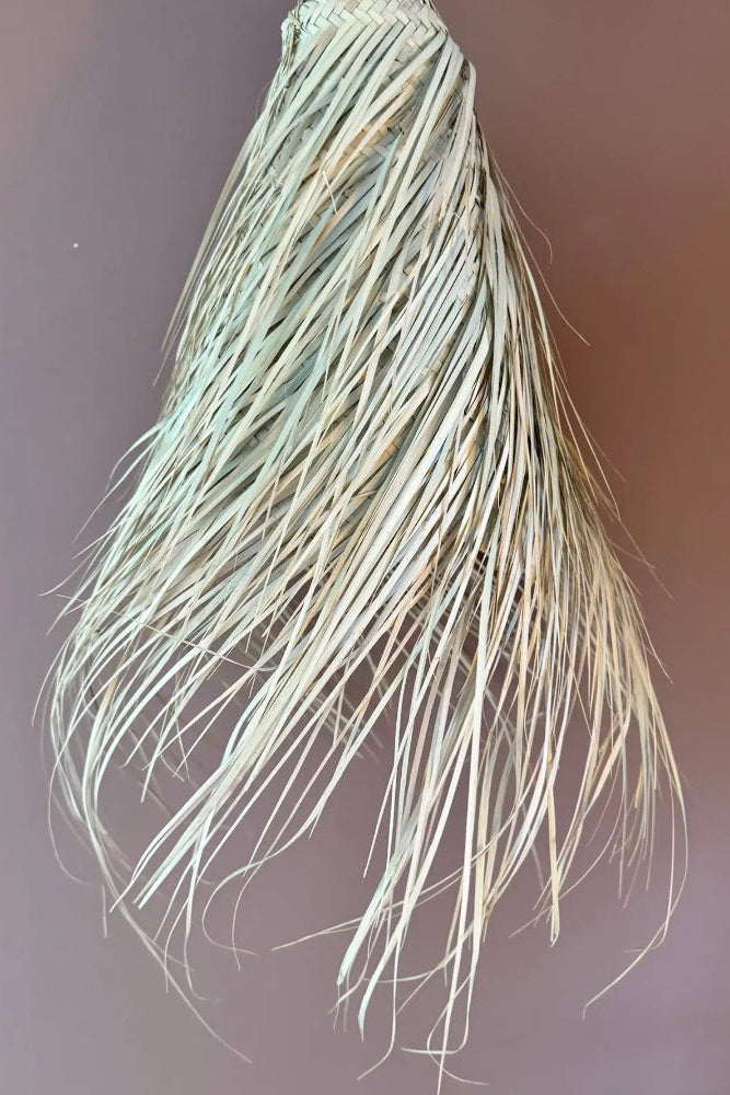 Handmade palm fibre lampshade Noor with natural beige tone and long fringes, full view.