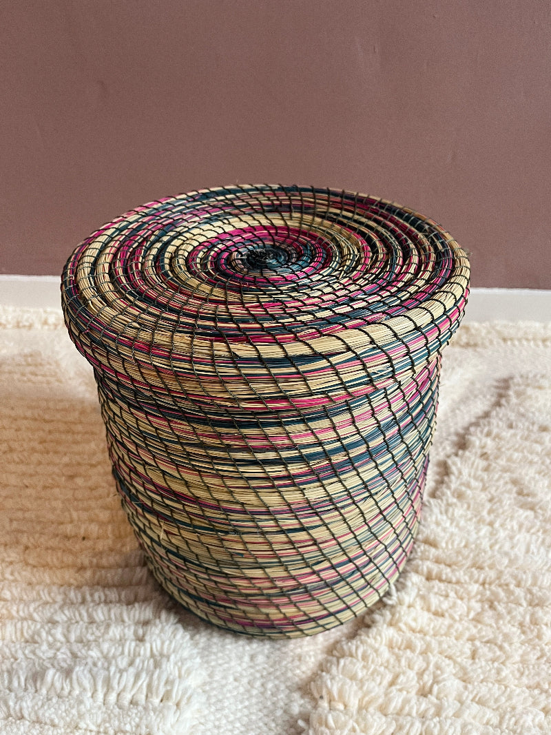 Overhead top view of Yara handmade straw basket in pink, green & cream.