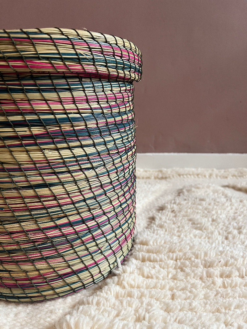 Side view detail showing pink, green, and cream woven pattern.